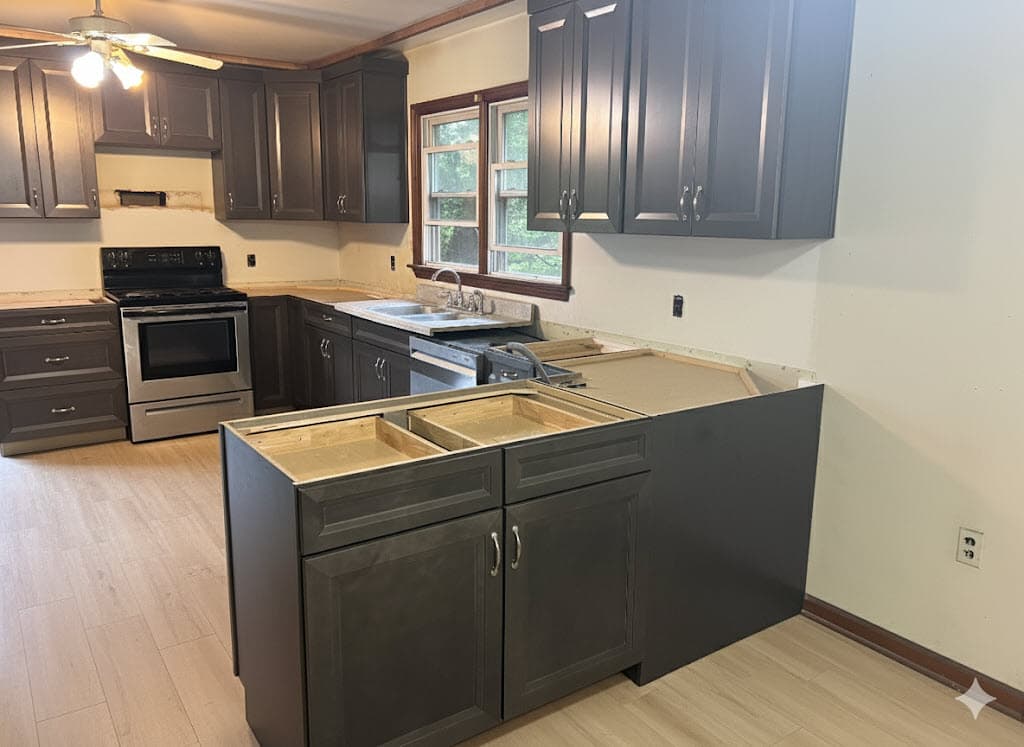 Modern kitchen remodel with dark cabinets and stainless steel appliances