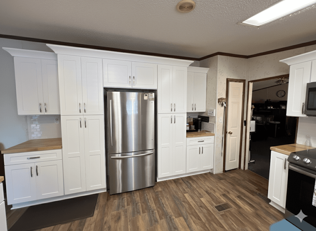 Modern white kitchen with butcher block countertops and stainless appliances